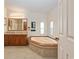 Bathroom boasts a large garden tub, double vanity, and tile flooring at 130 Tomoka Trail, Longs, SC 29568
