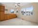 Spacious bedroom with wood cabinets, ceiling fan, and carpet at 130 Tomoka Trail, Longs, SC 29568
