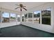 Bright screened porch with ceiling fan and green carpeting at 130 Tomoka Trail, Longs, SC 29568