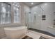 Spa-like bathroom with a freestanding tub, a walk-in shower, and patterned tile at 15 Melbourne Ct., Murrells Inlet, SC 29576