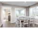 Bright dining room with a wooden table and chairs, and access to a porch at 2341 Elowen Ln. # 11E, Longs, SC 29568