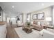 Spacious living room with beige sofa and hardwood floors at 2341 Elowen Ln. # 11E, Longs, SC 29568