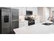Modern kitchen boasts stainless steel appliances and white cabinetry at 285 Bent Green Ct. # 76D, Murrells Inlet, SC 29576