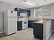 L-shaped galley kitchen with dark cabinets and white appliances at 301 Chester St. # B, Myrtle Beach, SC 29577