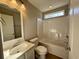 Bathroom with tub, toilet, vanity, and window at 407 West Virginia Rd., Georgetown, SC 29440