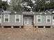 Small gray guest house with metal roof and double doors at 410 Pearl St., Conway, SC 29527