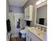 Clean bathroom with white vanity, shower, and stone-look floor at 4717 Wild Iris Dr. # 29-303, Myrtle Beach, SC 29577