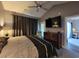 Main bedroom with king bed, dresser, and access to the bathroom and patio at 4717 Wild Iris Dr. # 29-303, Myrtle Beach, SC 29577