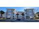 Two-story building exterior with stone accents and palm trees at 4717 Wild Iris Dr. # 29-303, Myrtle Beach, SC 29577