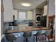 Modern kitchen with white cabinets, gray countertops, and bar seating at 4717 Wild Iris Dr. # 29-303, Myrtle Beach, SC 29577