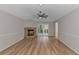 Living room with fireplace, hardwood floors, and sliding glass doors at 494 Saluda River Rd., Myrtle Beach, SC 29588