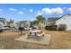 Community picnic table and grill area with parking lot view at 5870 Longwood Dr. # 201, Murrells Inlet, SC 29576