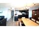 Open concept kitchen with dark wood cabinets and view to dining area at 5905 S Kings Highway # 545-B, Myrtle Beach, SC 29575