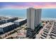 Aerial view of oceanfront high-rise building with parking and surrounding landscape at 5907 South Kings Hwy. # 308, Myrtle Beach, SC 29575