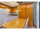 Small condo kitchen with light wood cabinets, white appliances, and a small dining table at 5907 South Kings Hwy. # 308, Myrtle Beach, SC 29575