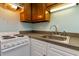 Small galley kitchen with white cabinets and appliances at 5907 South Kings Hwy. # 308, Myrtle Beach, SC 29575
