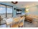 Condo living room with sofa, small table, and dining area near balcony at 5907 South Kings Hwy. # 308, Myrtle Beach, SC 29575