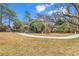 Landscaped backyard with a winding path and wooden fence at 6011 Dick Pond Rd., Myrtle Beach, SC 29588