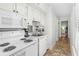 Well-equipped kitchen featuring white cabinetry and modern appliances at 9400 Shore Dr. # 312, Myrtle Beach, SC 29572