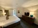 King-size bed, dresser, and a view into the kitchenette at 1105 S Ocean Blvd. # 334, Myrtle Beach, SC 29577