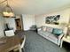 Bright living room with sofa, dining table, and access to other rooms at 1105 S Ocean Blvd. # 334, Myrtle Beach, SC 29577