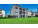Exterior view of a multi-unit building with green lawn at 1192 River Oaks Dr. # 28-B, Myrtle Beach, SC 29579