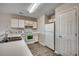 White kitchen cabinets, laminate floors, and stainless steel appliances at 1192 River Oaks Dr. # 28-B, Myrtle Beach, SC 29579