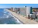 High-rise building on a beach, with ocean and other buildings visible at 1210 N Waccamaw Dr. # 404, Garden City Beach, SC 29576