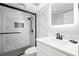 Modern bathroom with white marble tile and black fixtures at 1210 N Waccamaw Dr. # 404, Garden City Beach, SC 29576