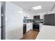 Modern kitchen with white cabinets, stainless steel appliances, and marble backsplash at 1210 N Waccamaw Dr. # 404, Garden City Beach, SC 29576