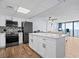 Modern kitchen with white cabinets and stainless steel appliances at 1210 N Waccamaw Dr. # 404, Garden City Beach, SC 29576