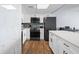 Modern kitchen with white cabinets, stainless steel appliances, and marble backsplash at 1210 N Waccamaw Dr. # 404, Garden City Beach, SC 29576