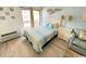 Bedroom with bed, light blue walls, and access to balcony at 202 75Th Ave N # 5704/5705, Myrtle Beach, SC 29572