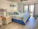 King bedroom with balcony access and coastal decor at 202 75Th Ave N # 5704/5705, Myrtle Beach, SC 29572