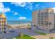 Oceanfront view of beach and two buildings, with parking and palm trees at 202 75Th Ave N # 5704/5705, Myrtle Beach, SC 29572