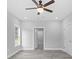 Spacious bedroom with ceiling fan, grey tile floors and large window at 5575 Dinkler Ave., Loris, SC 29569