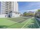 Green tennis court with shuffleboard court and building at 601 Mitchell Dr. # 104, Myrtle Beach, SC 29577