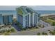 Aerial view of oceanfront resort, featuring a parking lot and nearby beach at 6804 N Ocean Blvd. # 1147, Myrtle Beach, SC 29572