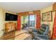 Living room with comfy recliner, TV, and balcony access at 6804 N Ocean Blvd. # 1147, Myrtle Beach, SC 29572