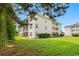 Building exterior showcasing the three-story building with lush green surroundings at 1278 River Oaks Dr. # 10C, Myrtle Beach, SC 29579