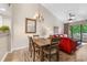 Bright dining area with wood table and chairs, view into living room and kitchen at 204 Baslow Ct. # 20-H, Myrtle Beach, SC 29572