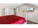 Main bedroom with red bedding and access to bathroom at 204 Baslow Ct. # 20-H, Myrtle Beach, SC 29572