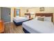 Bedroom with two double beds, nightstands, and wood floors at 201 77Th Ave. N # 923, Myrtle Beach, SC 29572