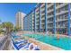 Large pool with plenty of lounge chairs for sunbathing at 201 77Th Ave. N # 923, Myrtle Beach, SC 29572