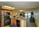 Open kitchen with granite countertops, black appliances, and ocean view at 2301 S Ocean Blvd. # Ph22, Myrtle Beach, SC 29577