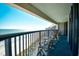 Balcony with chairs offering beautiful ocean views and beach access at 2301 S Ocean Blvd. # Ph22, Myrtle Beach, SC 29577