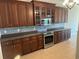 Well-equipped kitchen with dark wood cabinets and tiled backsplash at 249 Venice Way # 3105, Myrtle Beach, SC 29577