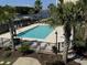 Community pool with lounge chairs and palm trees at 249 Venice Way # 3105, Myrtle Beach, SC 29577