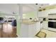 Kitchen with white cabinets, gas range, and breakfast bar at 4633 Lightkeepers Way # 5-C, Little River, SC 29566