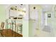 Kitchen with breakfast bar, white cabinets, and view into living area at 4633 Lightkeepers Way # 5-C, Little River, SC 29566